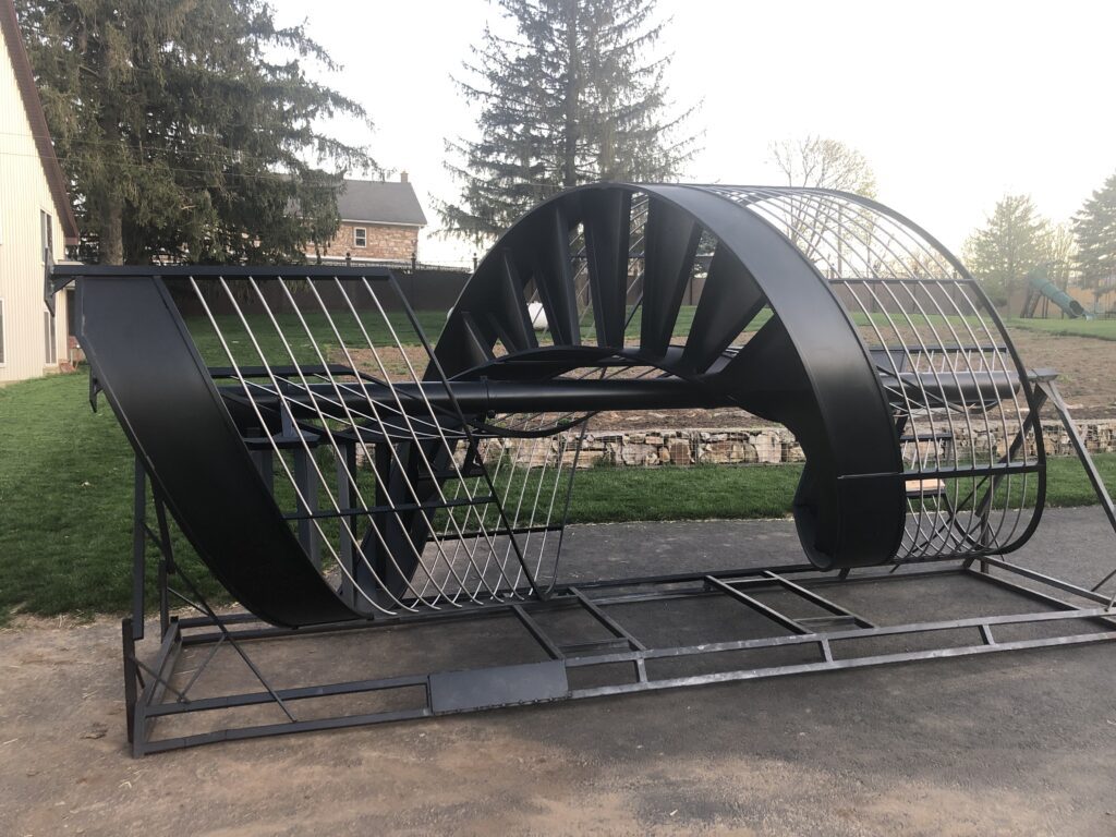 iron spiral staircase with black powder coating, laying on ground