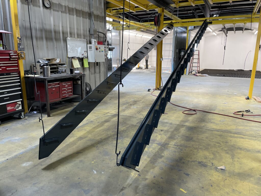 framework of a metal staircase after the powder coating process, colored black